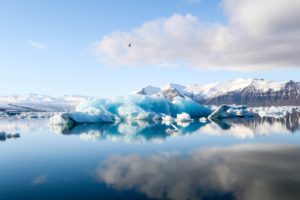 ice bergs and alp mountains facing calm body of water